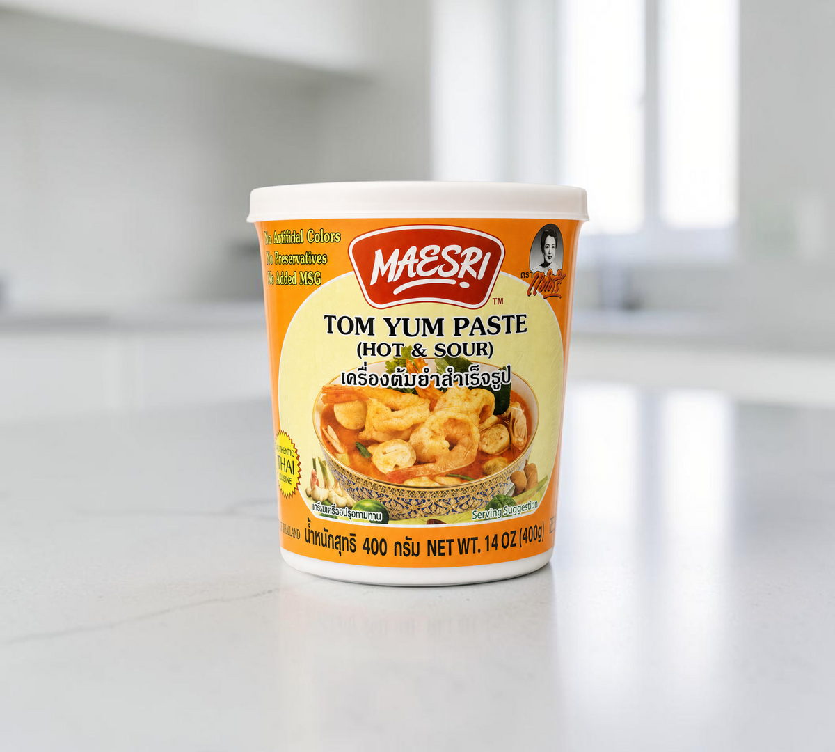 Thai Ranee Mae Sri Tom Yum hot and sour cooking paste in a 400g plastic tub with Thai soup serving suggestion
