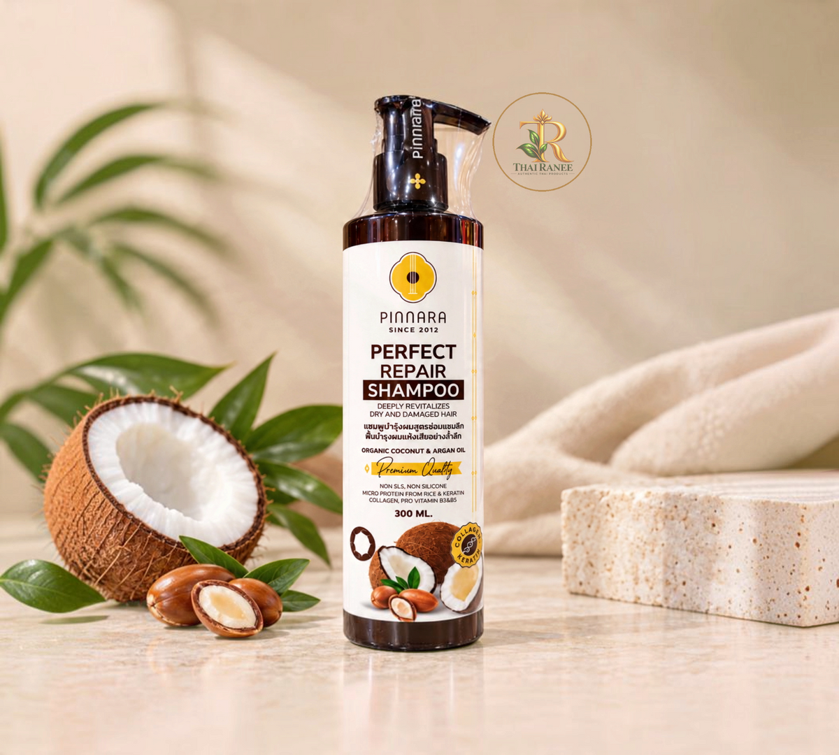 Thai Ranee Pinnara Perfect Repair Shampoo bottle with coconut and argan oil, featuring a pump dispenser.