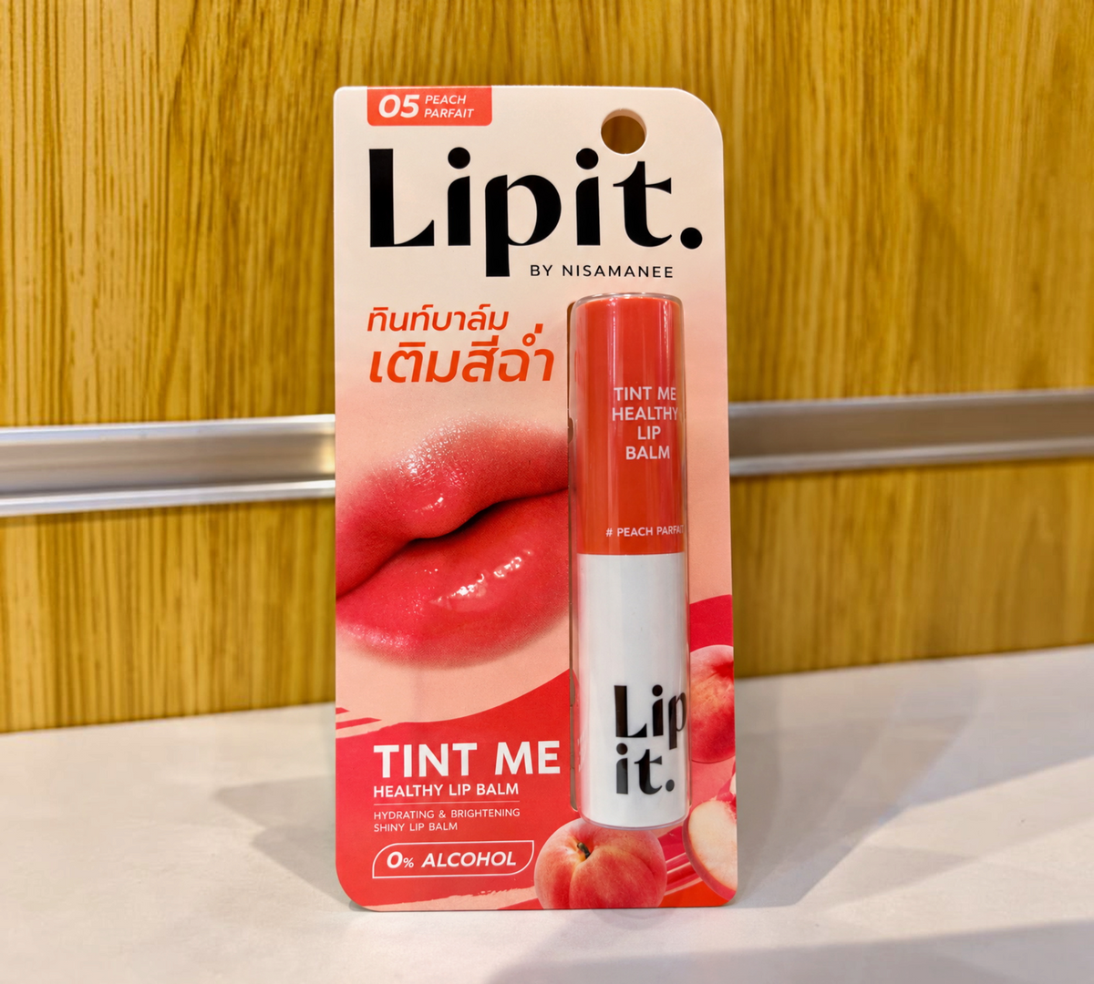 Thai Ranee Lipit. by Nisamanee Tint Me Healthy Lip Balm in 05 Peach Parfait, a hydrating and brightening peach tint.