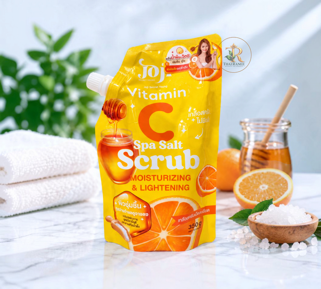 Thai Ranee Joji Secret Young Vitamin C Spa Salt Scrub in a yellow pouch with honey and orange imagery