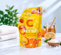 Thai Ranee Joji Secret Young Vitamin C Spa Salt Scrub in a yellow pouch with honey and orange imagery