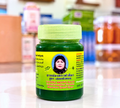 Thai Ranee Fatima Green Balm Saletphangphon herbal ointment in a green jar with a portrait label