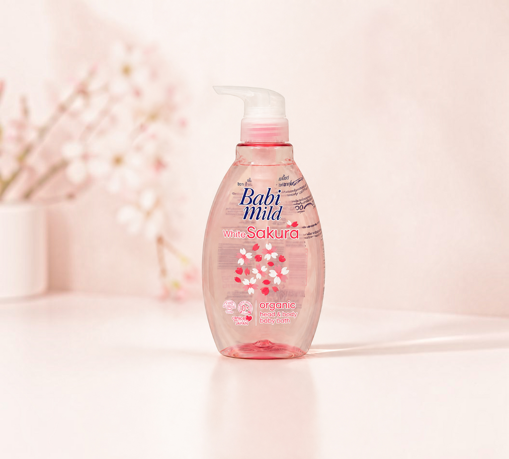 Thai Ranee Babi Mild White Sakura organic head and body baby bath in a 380ml pump bottle with floral background.