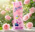 Thai Ranee BeNice Enchanted Bloom shower cream in a pink bottle surrounded by fresh pink roses in a garden setting.