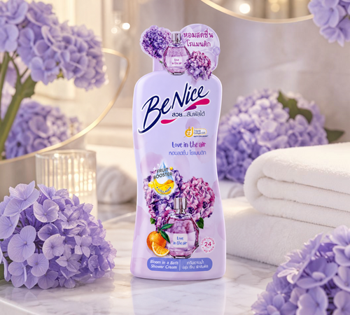 Thai Ranee BeNice Love In The Air Bloom shower cream bottle with floral hydrangea and orange accents on a marble tray