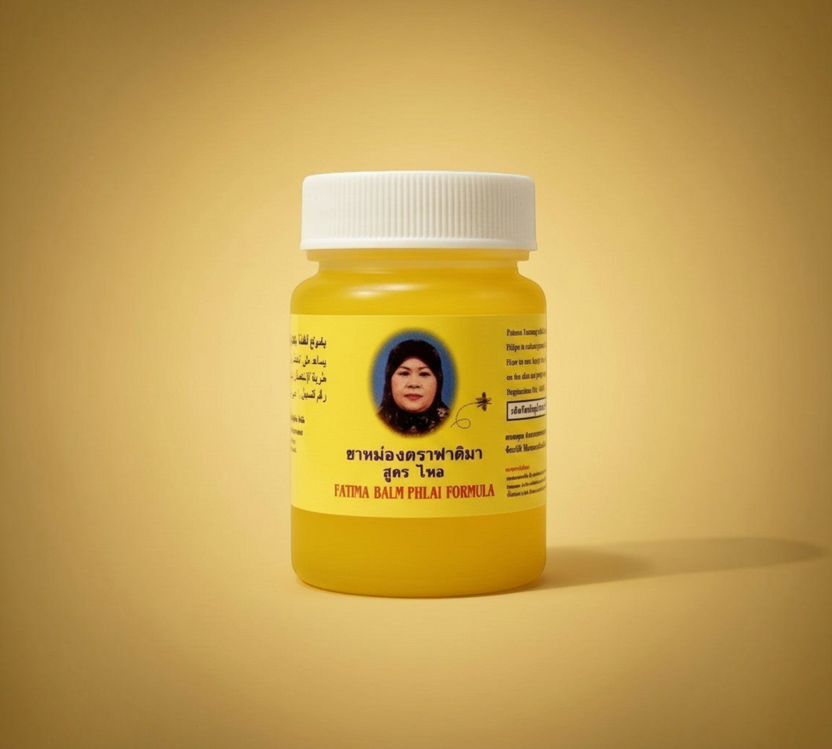 Thai Ranee Fatima Balm Phlai Formula herbal relief balm in a yellow jar for soothing muscle aches and tension.