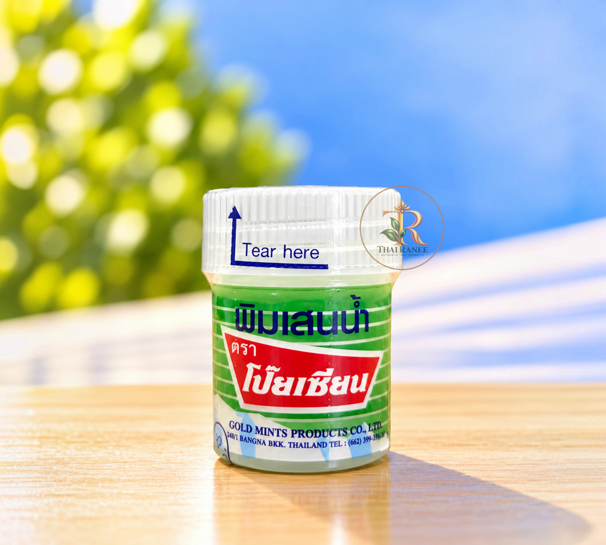 Thai Ranee traditional herbal medicated balm in a compact green bottle for quick relief and refreshing aromatherapy.