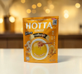 Thai Ranee HOTTA instant ginger beverage with Manuka honey in a golden yellow pouch with reduced sugar formula.
