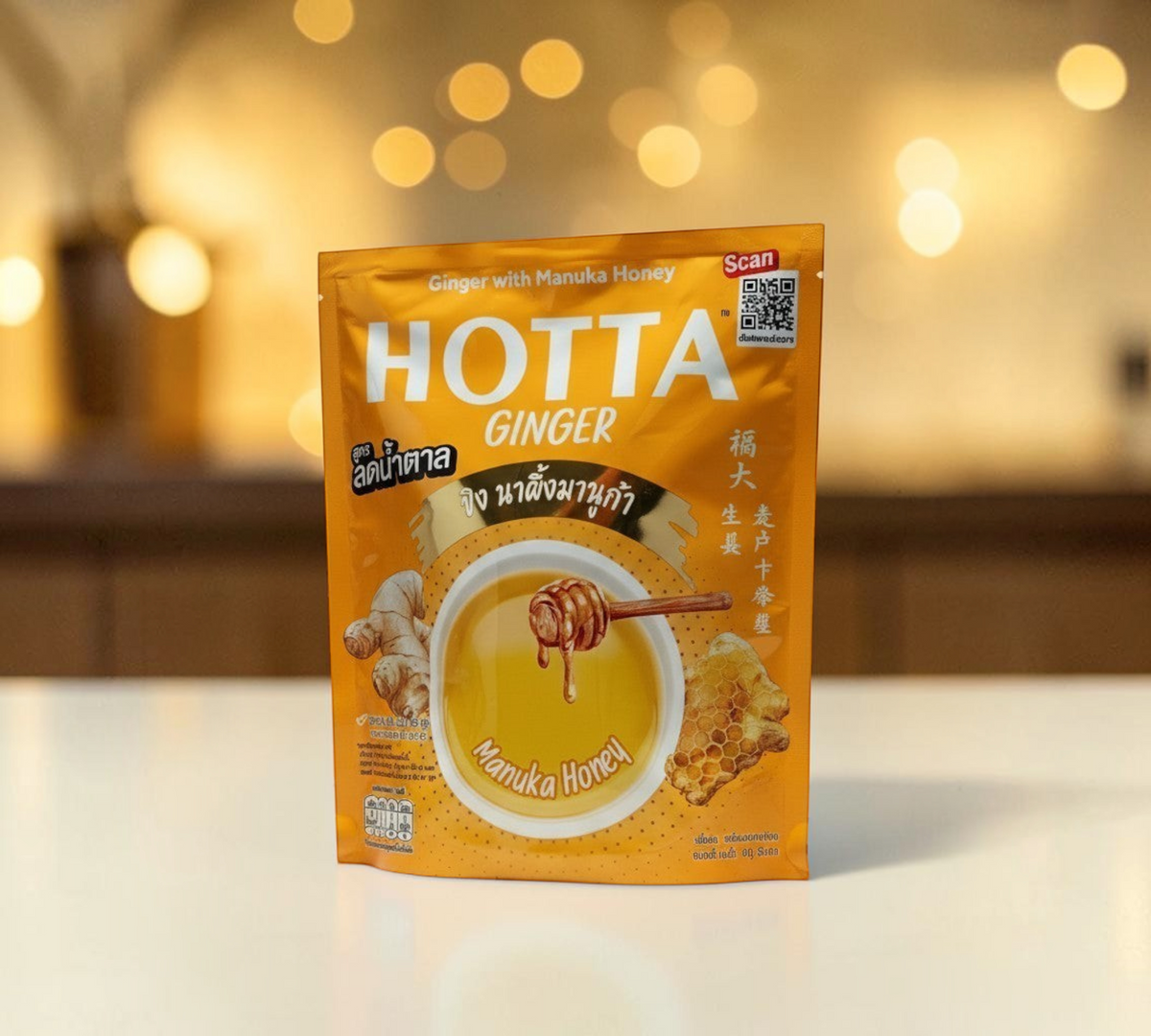 Thai Ranee HOTTA instant ginger beverage with Manuka honey in a golden yellow pouch with reduced sugar formula.