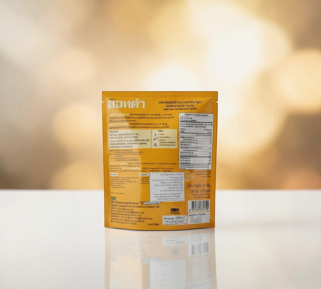 Thai Ranee HOTTA instant ginger beverage with Manuka honey in a golden yellow sachet, back view with product details.