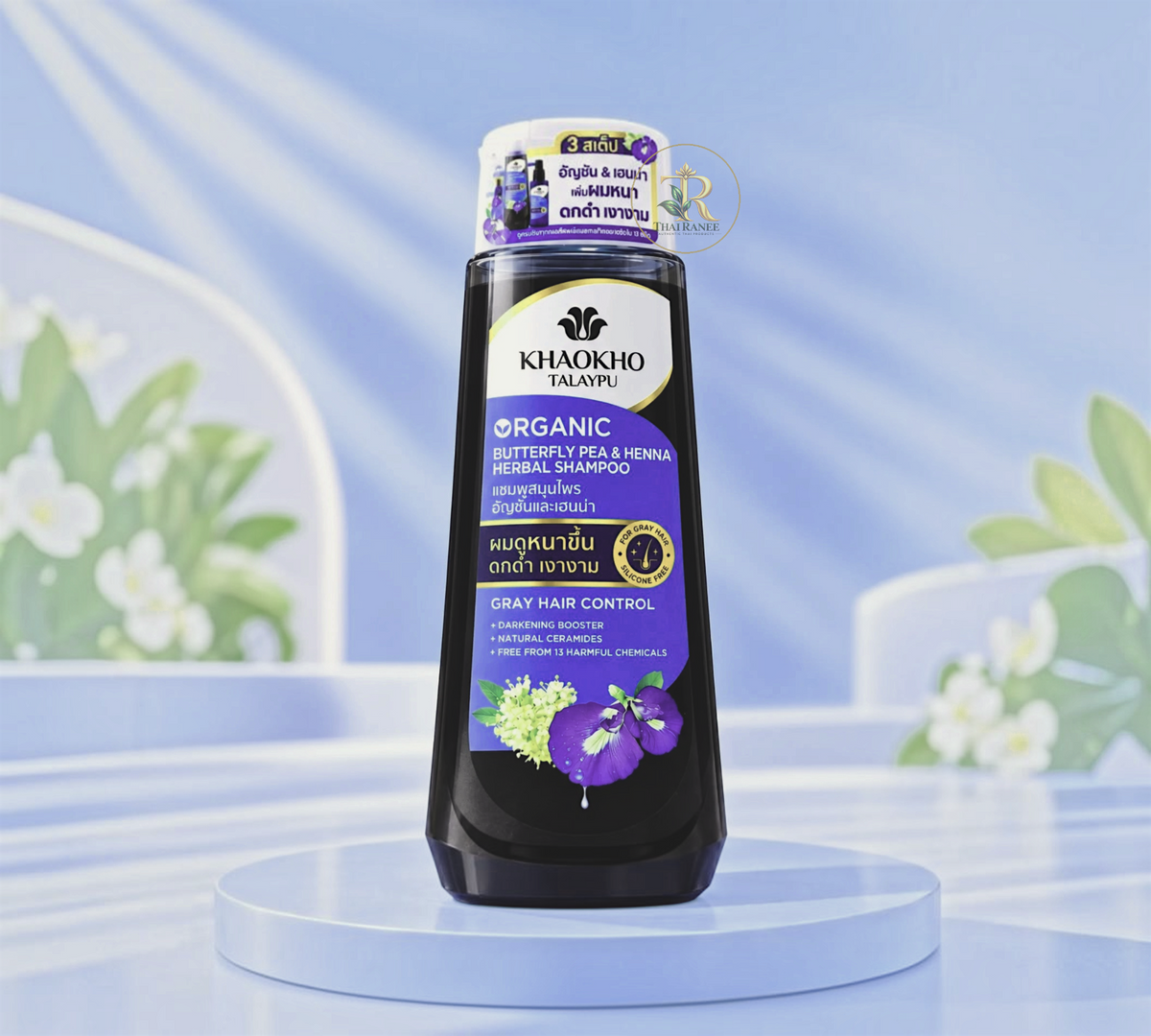 Thai Ranee Khaokho Talaypu organic butterfly pea and henna herbal shampoo bottle for gray hair control on blue stand
