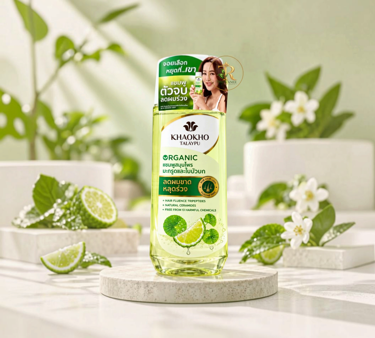 Thai Ranee Khaokho Talaypu organic bergamot and centella shampoo bottle for hair loss on a stone pedestal