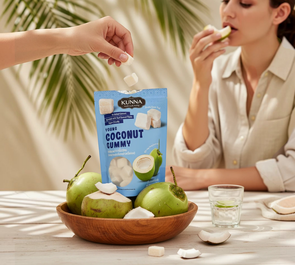 Thai Ranee KUNNA young coconut gummy pouch with fresh coconut pieces in a wooden bowl on a sunny table