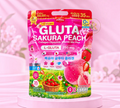 Thai Ranee Mikeo Gluta Sakura Peach collagen supplement powder pack with strawberry and peach fruit illustrations.
