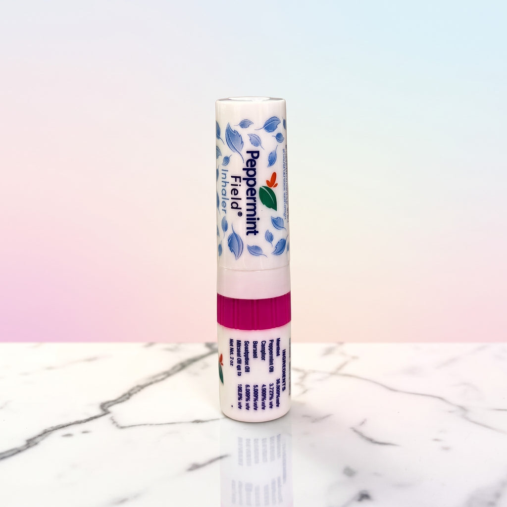 Thai Ranee Peppermint Field herbal inhaler with menthol and eucalyptus in a compact 2cc white tube on marble surface