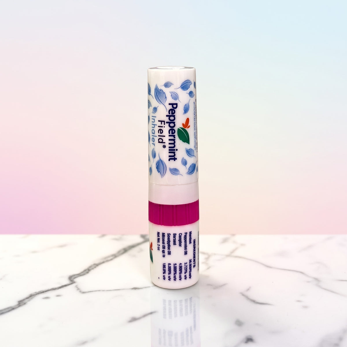 Thai Ranee Peppermint Field herbal inhaler with menthol and eucalyptus in a compact 2cc white tube on marble surface