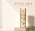 Thai Ranee Pinnara coconut oil serum bottle with vitamin C and E for hair and skin nourishment on a display stand.