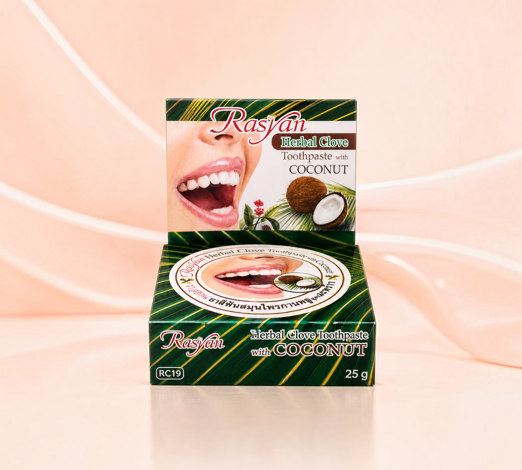 Thai Ranee Rasyan Herbal Clove Toothpaste with Coconut in a 25g box featuring a smile and coconut imagery.