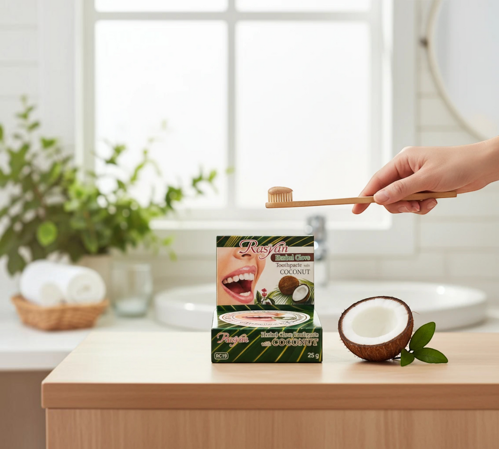 Thai Ranee Rasyan herbal clove and coconut toothpaste in a 25g box with a bamboo toothbrush and fresh coconut half