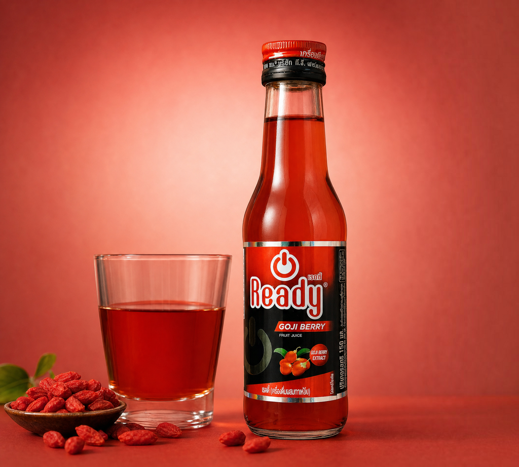 Thai Ranee Ready Goji Berry fruit juice energy drink in a 150ml glass bottle next to a glass and bowl of dried berries.