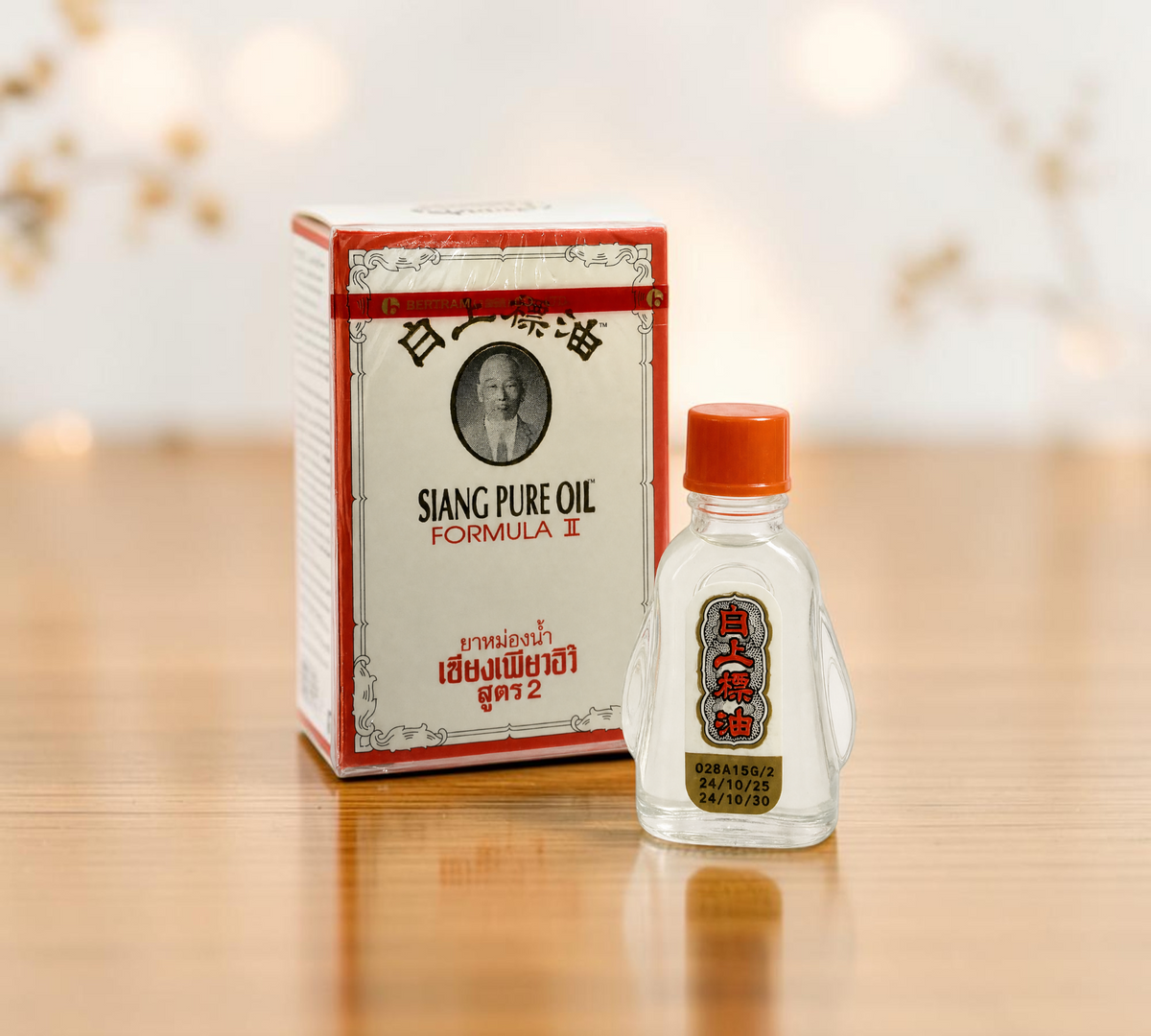 Thai Ranee Siang Pure Oil Formula II herbal oil in a 3cc clear bottle with orange cap next to its red and white box.