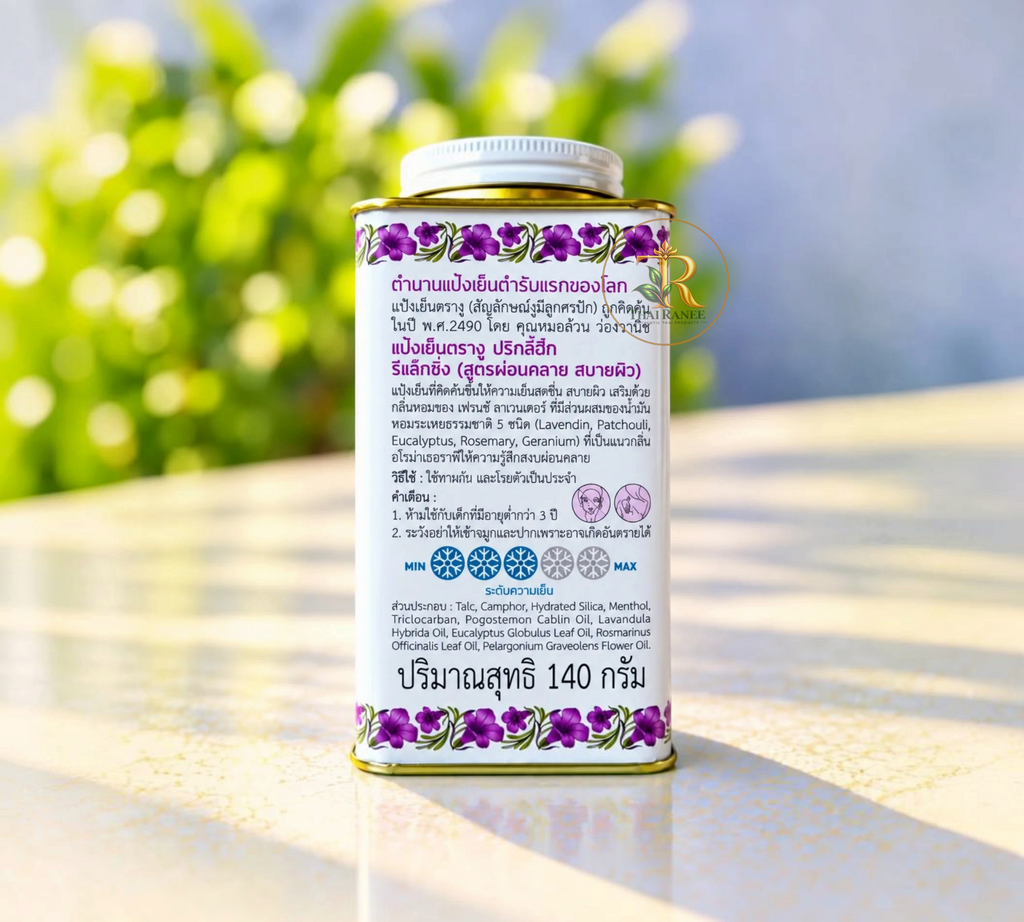Thai Ranee Snake Brand French Lavender cooling powder in a metal canister with floral accents on a sunny surface