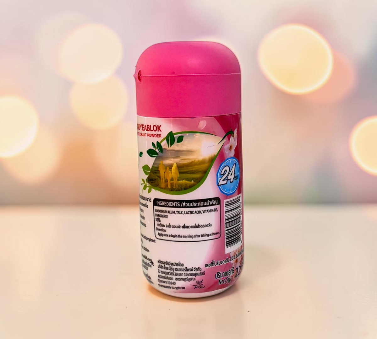 Thai Ranee Taoyeablok Sakura whitening deodorant powder in a pink bottle with 24-hour odour protection label