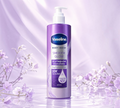Thai Ranee Vaseline Smooth Glow GlutaGlow body wash in a purple pump bottle with floral accents and water ripples.