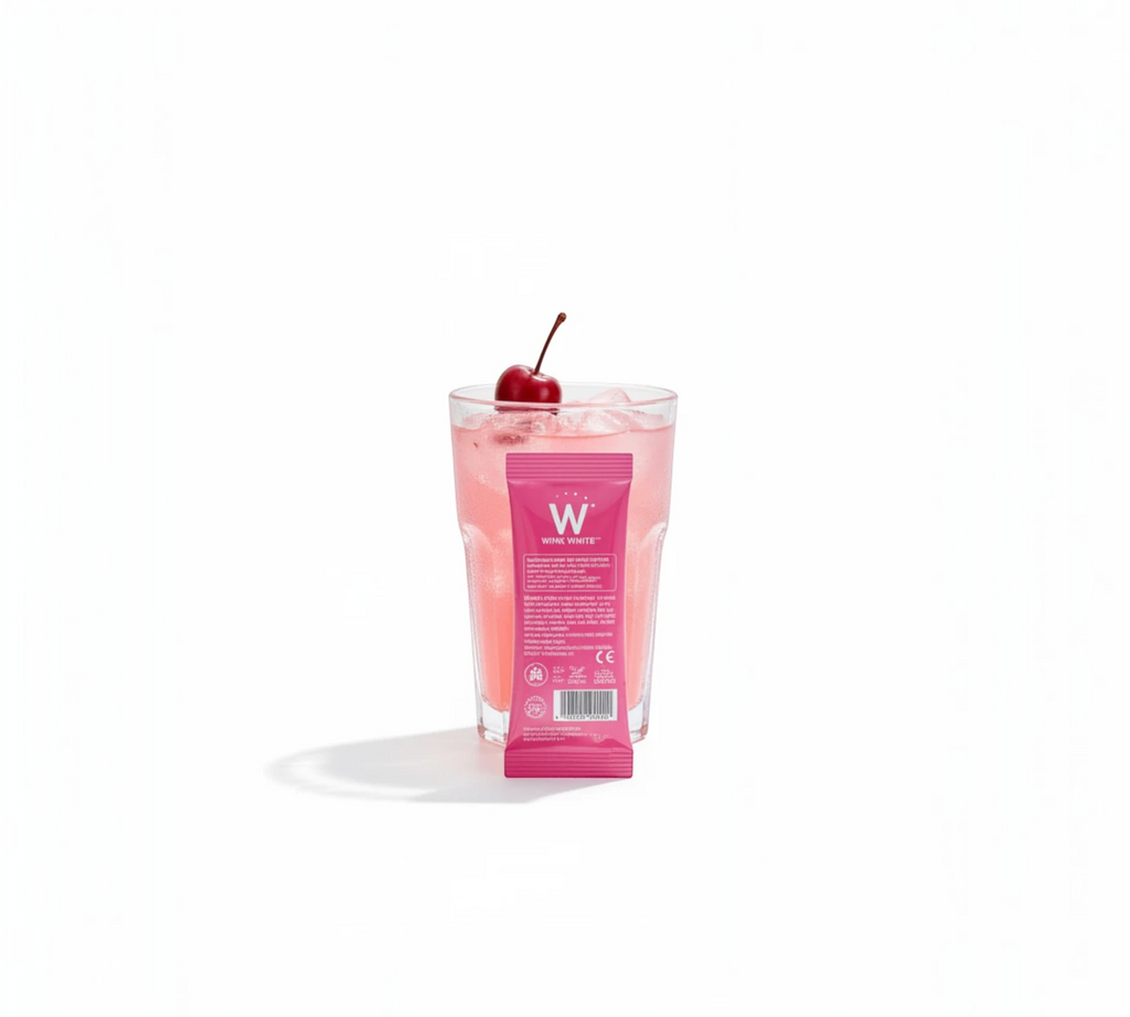 Thai Ranee Wink White Collagen Pink Glow Plus sachet in front of a glass of pink collagen drink with a cherry garnish